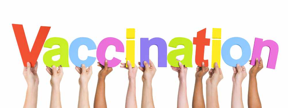 Multiethnic Arms Raised Holding Text Vaccination Multiethnic Arms Raised Holding Text Vaccination